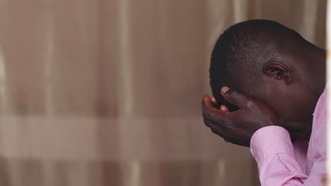 portrait-african-black-male-desperate-crying-alone-covering-his-face-in-tears-with-hands,-close-up-africa