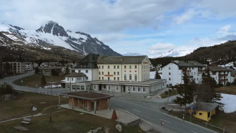 Scenic-reverse-aerial-view-of-Maloja-town-in-the-Alps-of-Switzerland