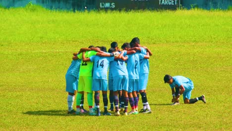 Young-teenager-boys-of-a-soccer-football-team-standing-in-a-circle-together-before-match-or-training-in-blue-clothes-4k