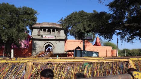 holly-temple-with-bunch-of-holy-hindu-thread-offerings-and-people-moving-in-line-at-afternoon-video-is-taken-at-kal-bhairav-temple-ujjain-madhya-pradesh-india-on-Mar-10-2024