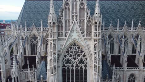 Detailed-view-of-the-intricate-Gothic-architecture-of-a-church-in-Vienna,-Austria,-featuring-ornate-spires-and-large-windows