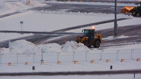 Snowplows-clearing-snow-at-an-airport-in-Toronto,-Canada,-during-January