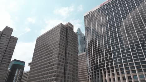 Looking-up-at-modern-skyline-and-skyscraper-office-buildings-architecture