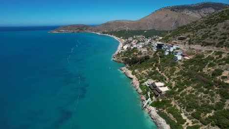 Ionian-Sea-with-Blue-Azure-Waters-and-Calm-Panoramic-Rocky-Beach-in-Albanian-Riviera:-Premier-Tourist-Summer-Destination