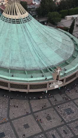 Aerial-view-of-Basilica-of-Guadalupe's-roof,-resembling-a-circular-mantle-in-green-coloration