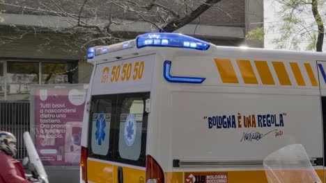 Blue-flashlights-and-siren-on-ambulance-car-in-Bologna,-Italy-providing-first-aid