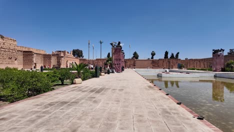 Badi-Palace-empty,-tourist-walking-inside-point-of-view-POV,-Marrakesh-Morocco