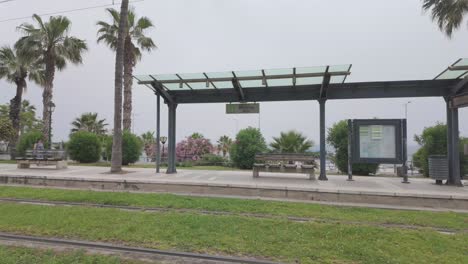 Electric-Tram-station-sea-coast-of-Piraeus-near-Athens,-Greece-public-transport