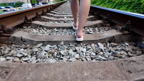 A-person-walks-along-railroad-tracks-in-Crimea-during-the-summer