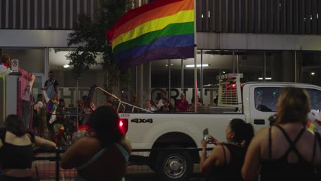 Truck-carrying-huge-Pride-flag-during-Pride-parade-and-celebration-in-Houston,-Texas