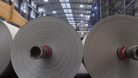 Several-giant-paper-rolls-appear-and-are-getting-ready-to-go-into-the-machine