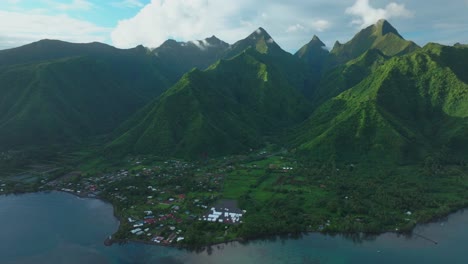 Summer-2024-Paris-OlympicsTeahupoo-Tahiti-aerial-drone-view-French-Polynesia-surfing-surfer-wave-venue-French-Polynesia-Pacific-Ocean-coral-reef-break-channel-mountains-sunset-afternoon-backwards-pan