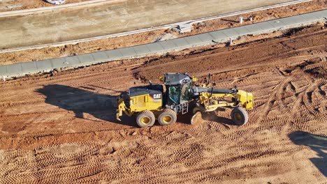 A-grader-and-a-front-end-loader-moving-around-working-at-a-construction-site