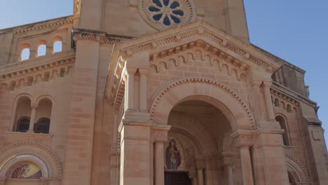 Observing-the-exterior-architecture-of-the-Basilica-of-the-Blessed-Virgin-of-Ta'-Pinu-on-Gozo-Island,-Malta,-during-daylight,-reflecting-the-spiritual-and-historical-significance-of-the-landmark