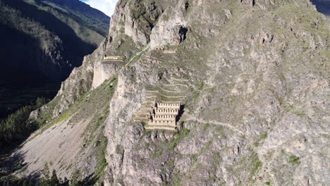 Panramic-high-angle-pan-overview-of-historic-town-site-of-Ollantaytambo-cut-out-of-hillside-in-Peru