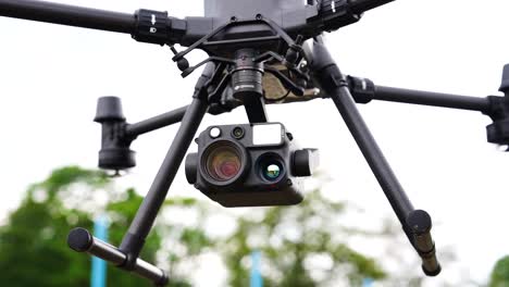 Close-up-of-advanced-camera-equipment-while-industrial-drove-hover-in-air