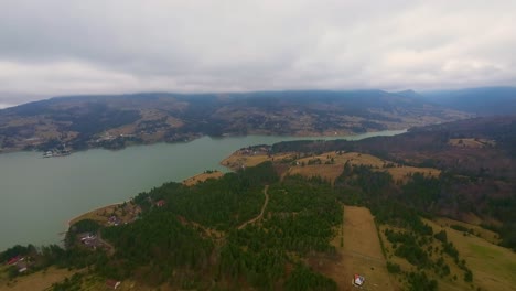 Parallax-drone-shot-of-Colibita-lake,-Transilvania,-Romania