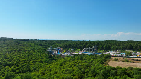 Drone-rising-in-front-of-a-large-waterpark,-sunny,-summer-day-in-Croatia