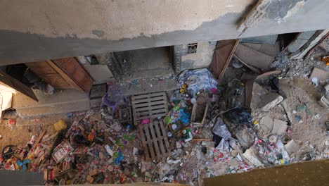 Damaged-building-rubbles-and-plastic-bottle-waste-during-Israel-Hamar-civil-war-conflict