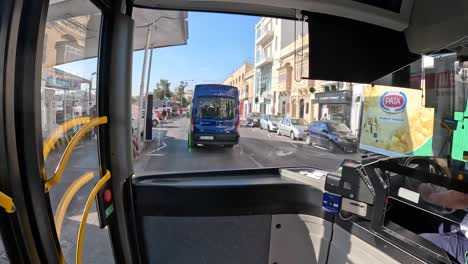 A-time-lapse-captured-from-a-public-bus-in-Valetta,-Malta,-showcasing-the-bustling-urban-transport-and-cityscape-dynamics