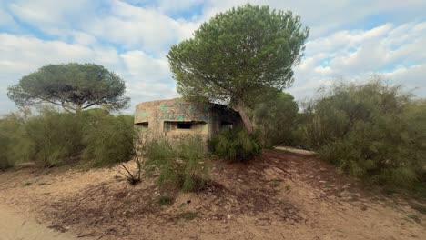 Walking-along-the-Spanish-seaside,-discover-a-historic-war-bunker,-reflecting-the-blend-of-natural-beauty-and-historical-significance