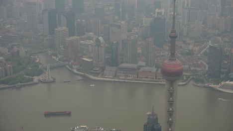 Oriental-Pearl-TV-Tower,-Huangpu-River-and-Shanghai-skyline-in-fog-at-sunset