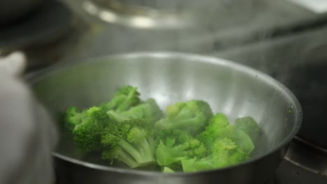 A-Chief-cooks-broccoli-on-a-grill-close-up-shot,-insert-shot