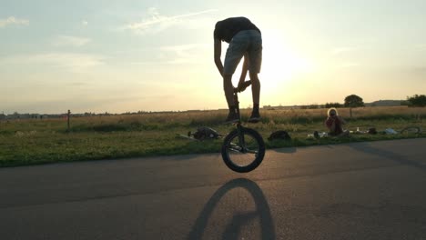 Junger-Und-Energischer-Einradfahrer,-Der-Im-Freien-Unter-Einem-Wunderschönen-Sonnenuntergangshimmel-Auf-Einem-Rad-Balanciert