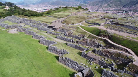Terraced-fields-with-stone-walls-of-old-culturally-significant-site-in-Peru,-aerial