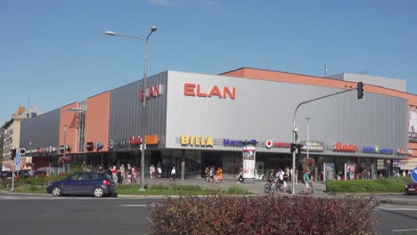 Cars-driving-in-front-of-Elan-department-store-in-Havirov,-Czech-Republic,-busy-junction