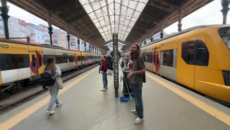 Commuters-waiting-for-trains-at-the-Sao-Bento-Train-Station-in-Porto,-Portugal