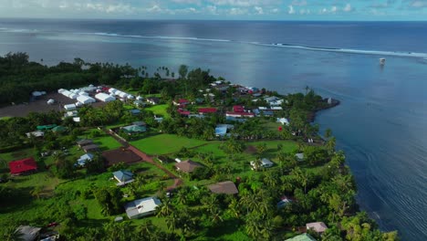 Teahupoo-Tahiti-town-Paris-2024-surfing-Summer-Olympics-venue-French-Polynesia-aerial-drone-sunny-morning-end-of-the-road-Point-Faremahoracoastline-beach-coral-reef-surf-waves-judge-tower-forward-pan