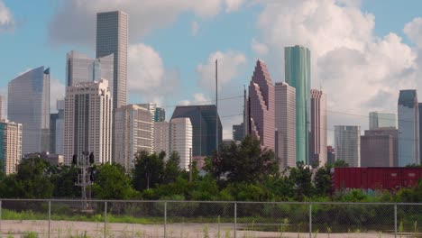 Timelapse-of-downtown-Houston,-Texas-as-train-goes-by