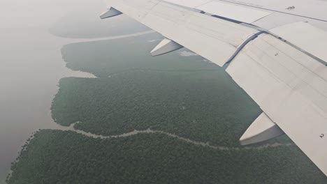 Wing-of-airplane-flying-above-clouds