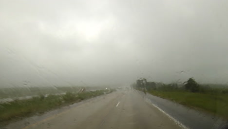 Driving-point-of-view-traveling-in-rainy-conditions-on-highway-with-windshield-wipers