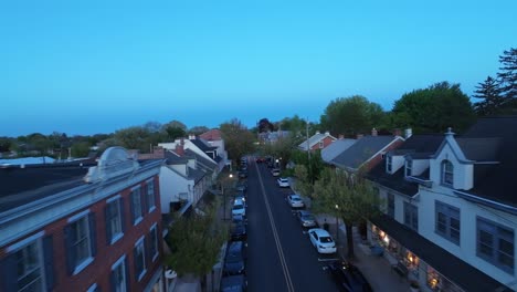 FPV-flight-over-main-street-of-american-town-at-dusk