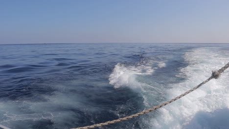 Sea-water-splashes-behind-a-ferry-near-Malta's-coastline,-embodying-the-spirit-of-maritime-adventure-and-exploration