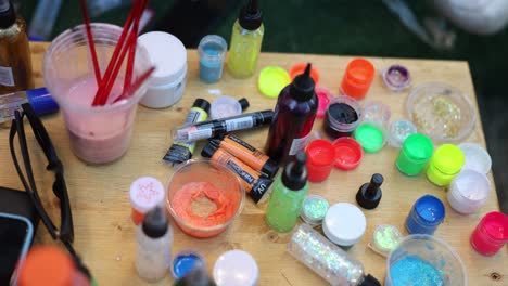 A-variety-of-colorful-art-supplies-arranged-on-a-table,-ready-for-a-creative-project
