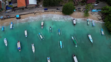 Birds-Eye-view-of-the-blue-water-in-Padang-Bai-bay-and-the-traditional-boats-for-tourists-snorkelling-and-scuba-trips