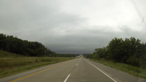Driving-point-of-view-traveling-in-cloudy-weather-on-interstate-highway