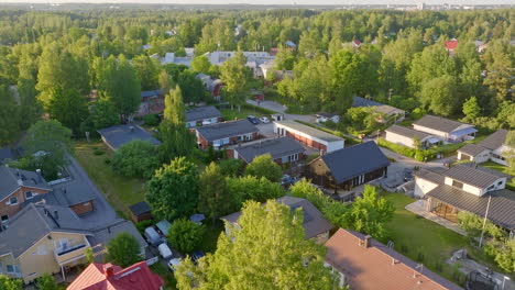 Drone-circling-contemporary-homes-in-a-community-of-Helsinki,-summer-in-Finland