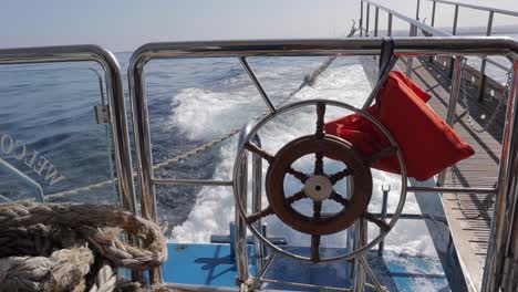 Sea-water-splashes-behind-a-ferry-near-Malta's-coastline,-embodying-the-spirit-of-maritime-travel-and-exploration