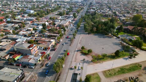 Traffic,-Avenue-of-Santiago-de-Chile-neighborhood,-aerial-fly-residential-homes-neighborhood-area-of-South-American-Andean-cordillera-city