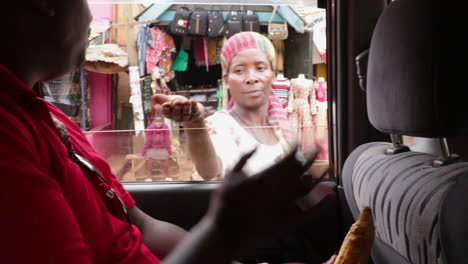 female-street-vendor-selling-foor-in-the-street-of-remote-african-road-with-market-stand-in-background