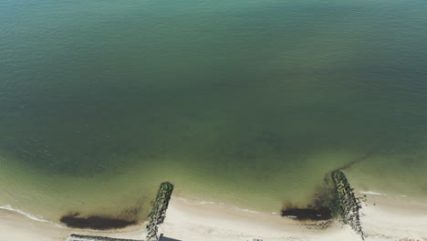 Drone-high-angle-pan-across-seawalls-and-private-beaches-on-Nantucket-sound