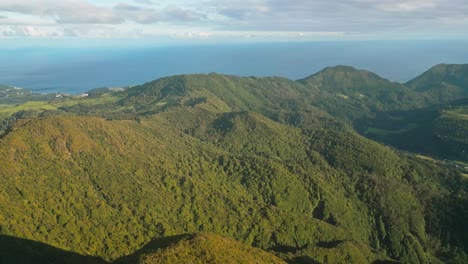 Lush-green-hills-and-ocean-in-furnas,-azores,-portugal,-aerial-view