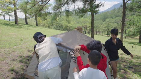 A-group-of-people-set-up-a-tent-on-a-picturesque-pine-covered-hill