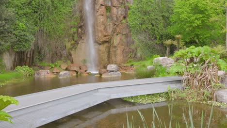 Footbridge-And-Waterfall-Plunging-At-Former-Misery-Quarry-Jardin-Extraordinaire-In-Nantes,-France