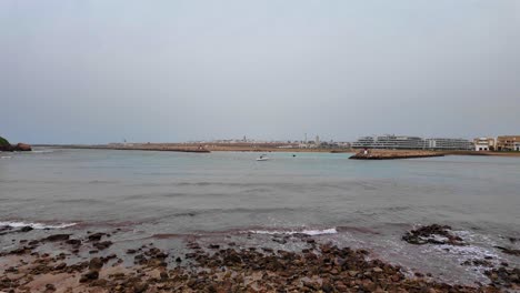 Rocky-beach-at-the-Atlantic-coast-ocean-in-Rabat,-Morocco,-slow-waves