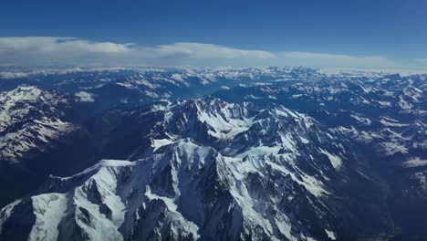 Elevated-aerial-close-up-view-of-The-Mont-Blanc-snowed-summit-shot-from-a-jet-cockpit-overflying-the-peak-at-8000m-high